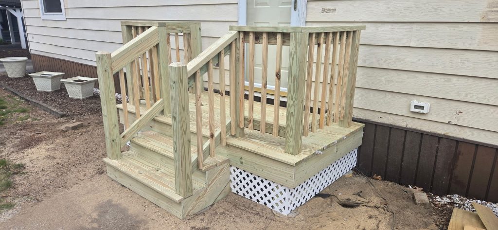 Newly constructed wooden porch steps and landing with safety railings
