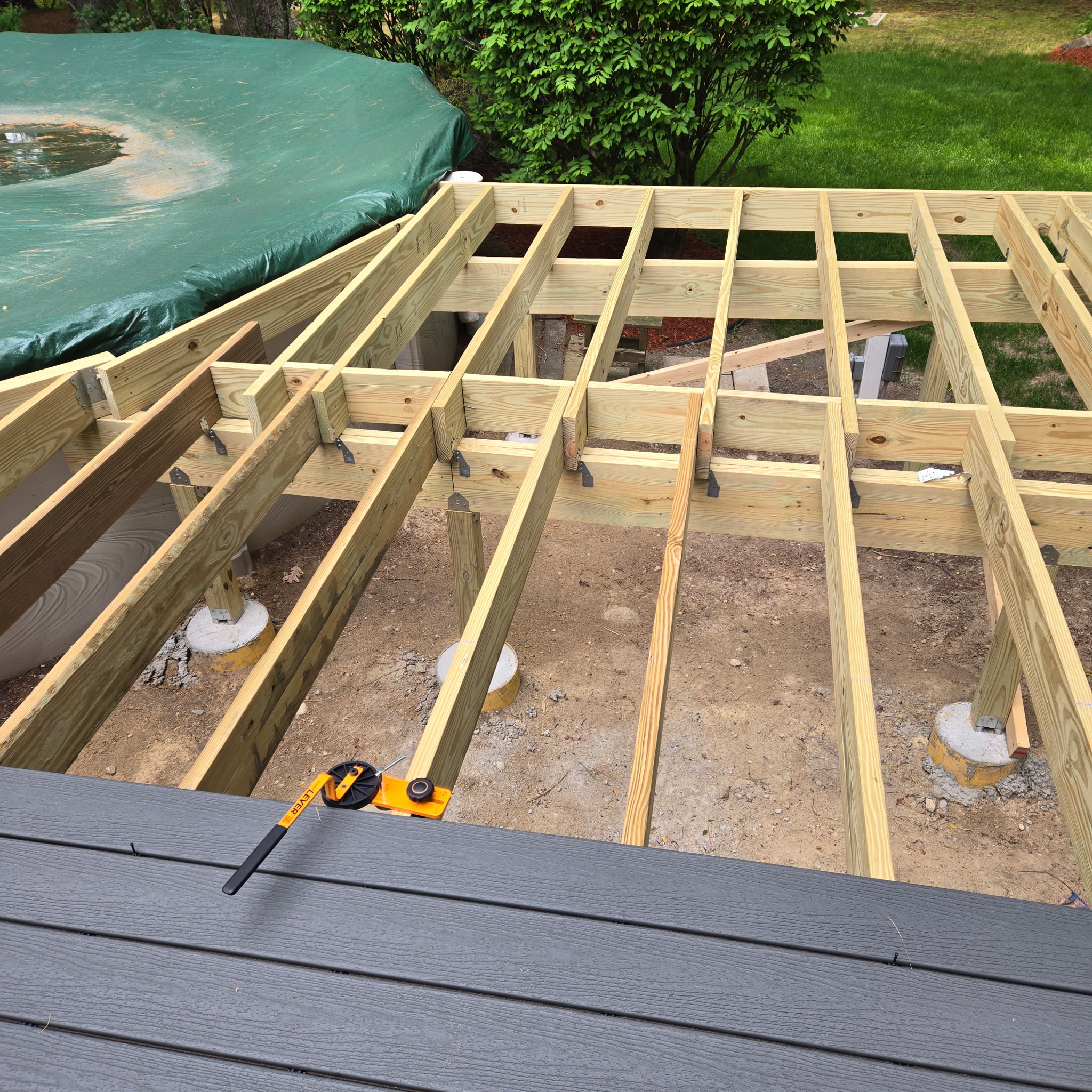 Custom pool deck framing and composite decking installation in progress by Chippy's Handyman.