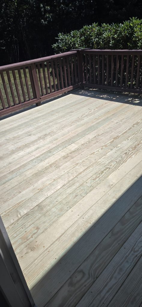 Newly installed pressure-treated deck surface completed during a rot restoration project