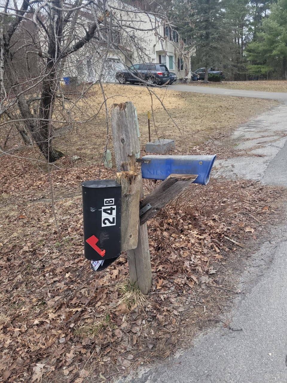 Decaying and broken wooden double mailbox post prior to replacement in Londonderry, NH.