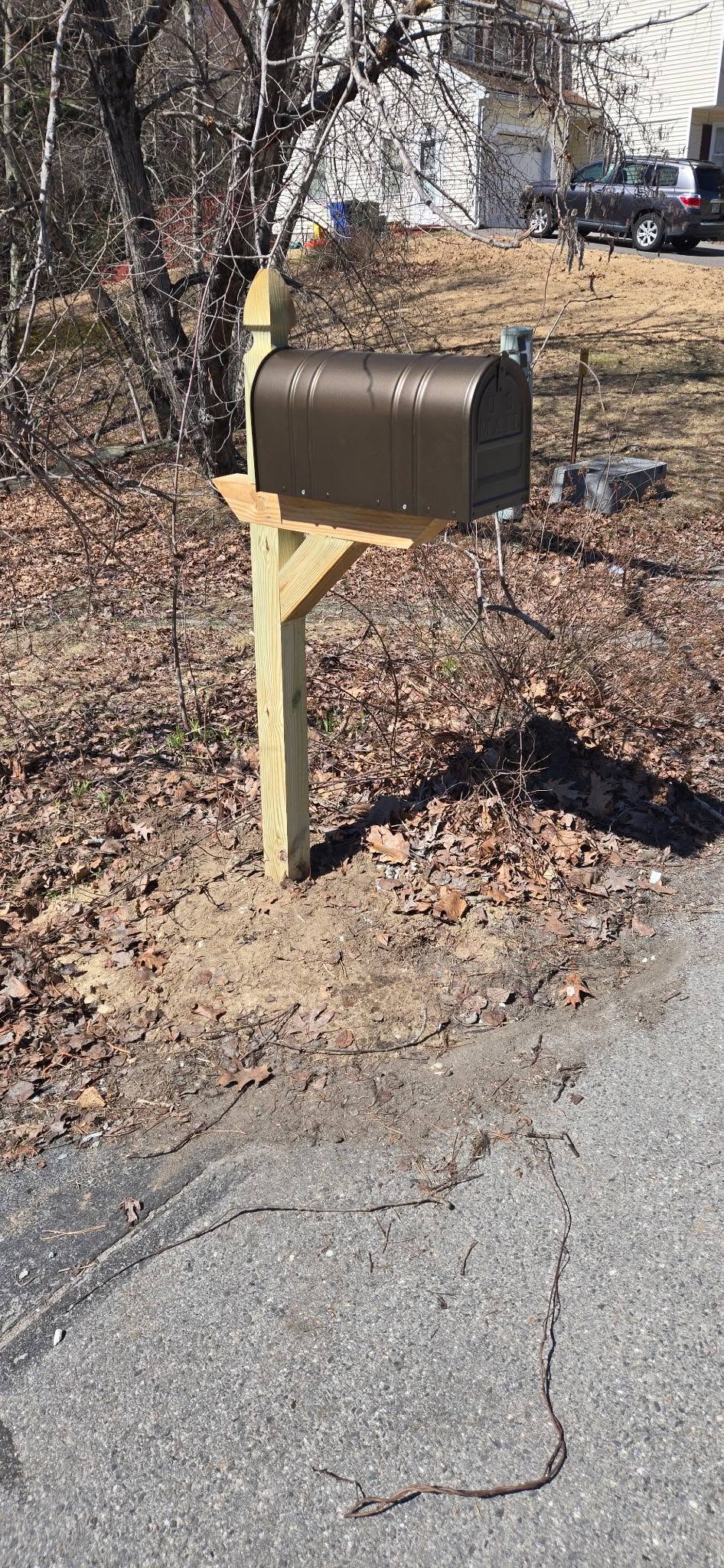 Brand new custom wooden mailbox post and bronze mailbox installed in Londonderry, NH.